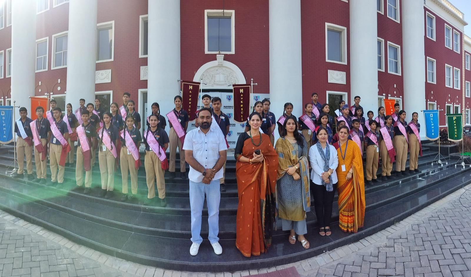 Students and teachers of Mavericks International School on the steps of the main building