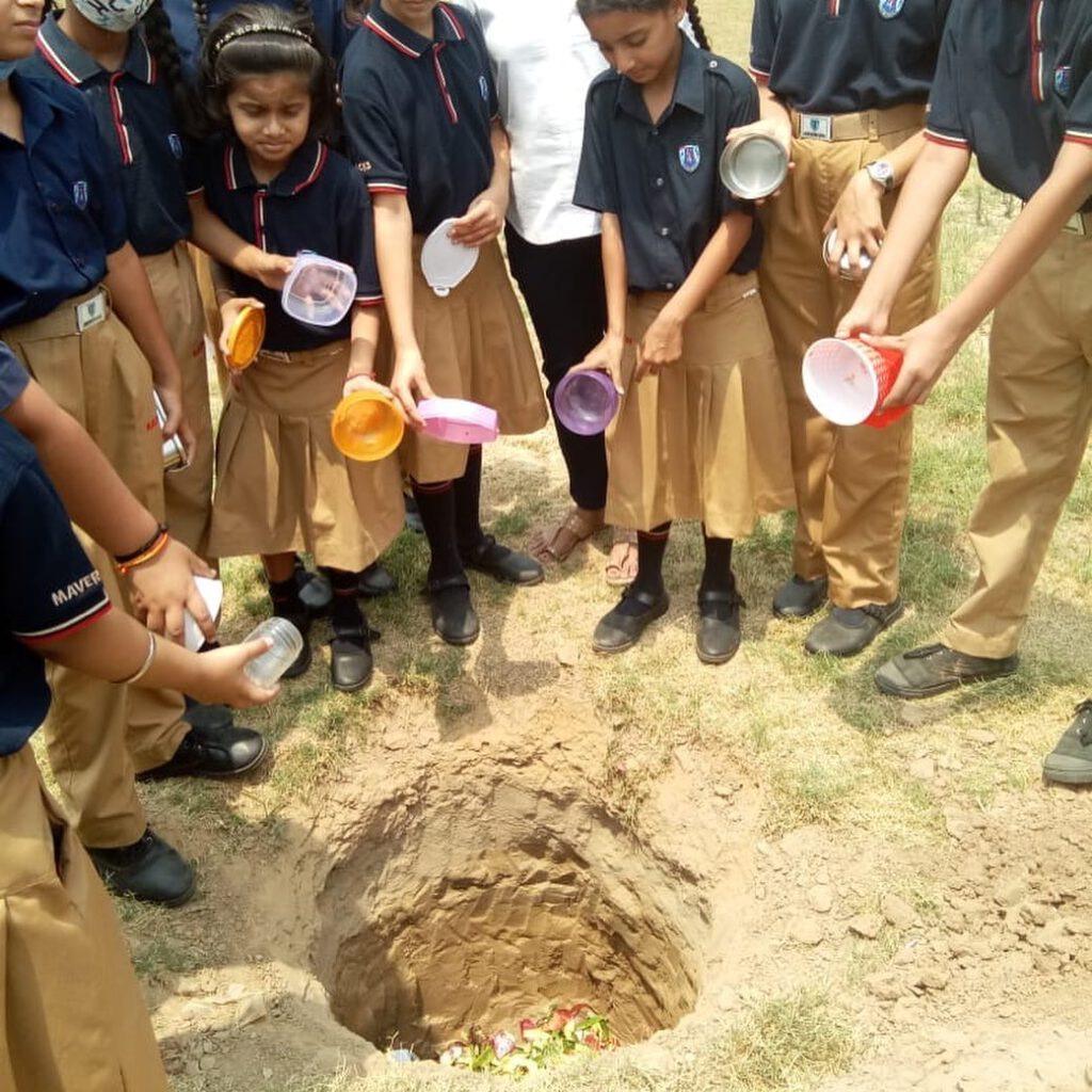 Students planting saplings for the Save Soil event