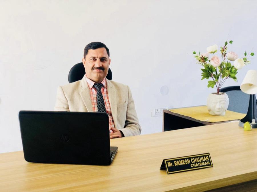 Mr. Ramesh Chauhan, Chairman, at his desk