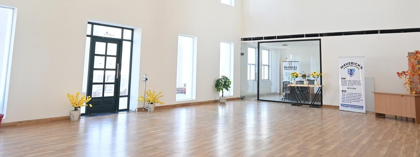 A bright, empty classroom with large windows